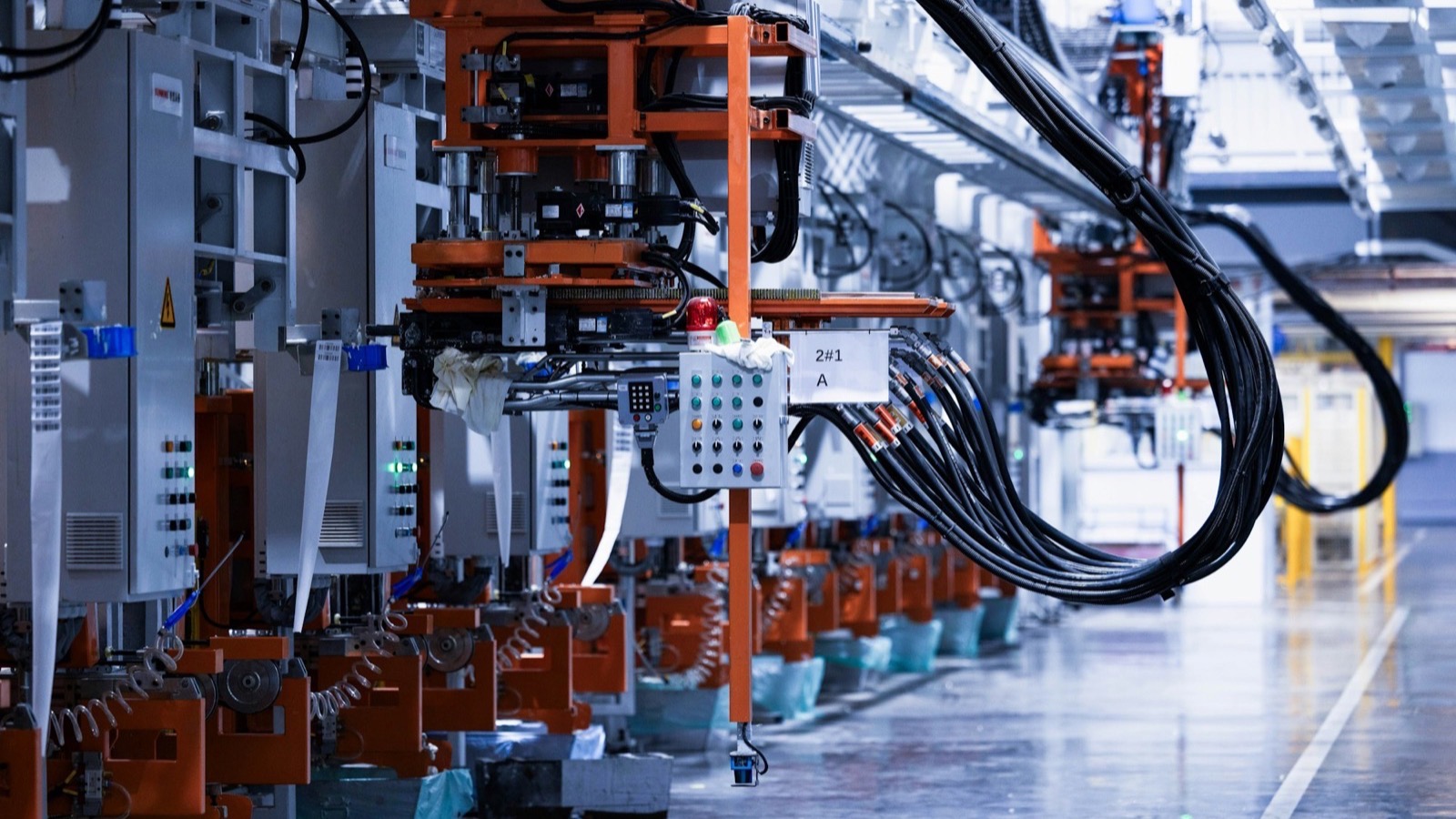 A modern factory production line standing idle with no workers present, representing Chinese factories closed for the National Day Golden Week holiday