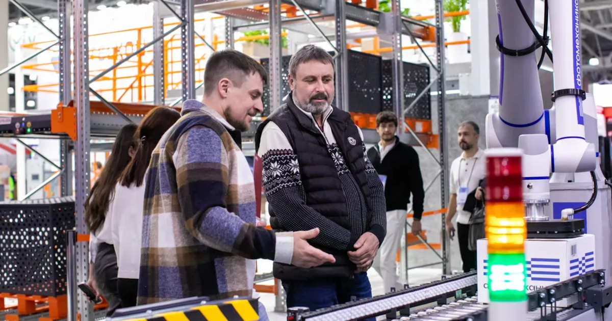 Team observing an automated conveyor system in a warehouse, representing how a China sourcing agent oversees production