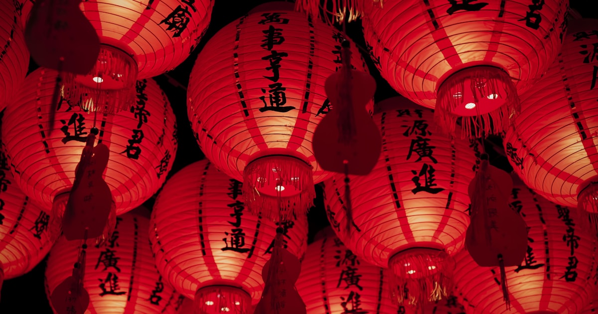 Dense cluster of traditional red Chinese lanterns, representing how Chinese New Year affects shipping schedules from China