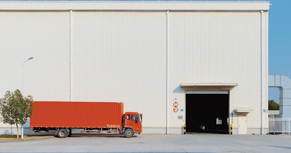 Cargo truck delivering goods at a warehouse dock, representing DDP door-to-door delivery from China to Bangladesh