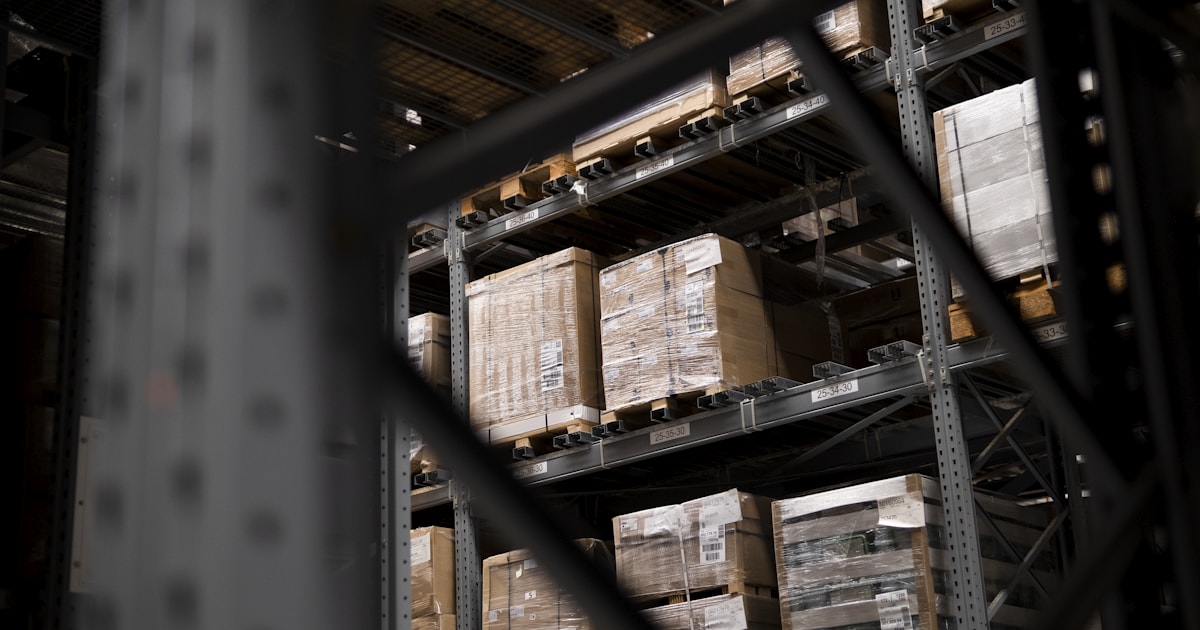 Warehouse stacked with boxes and pallets, illustrating how cargo consolidation cuts shipping costs