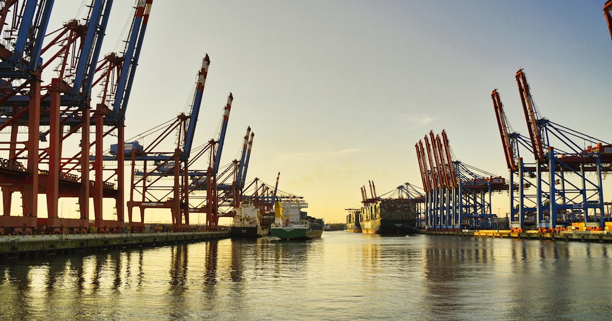 Port cranes loading cargo containers, representing import duties and taxes in Bangladesh