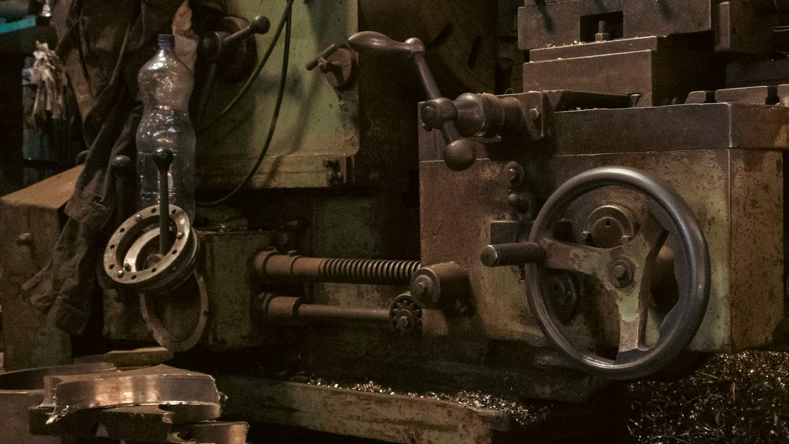 A heavily used metal lathe in a workshop, representing second-hand machinery whose remaining economic life has to be certified