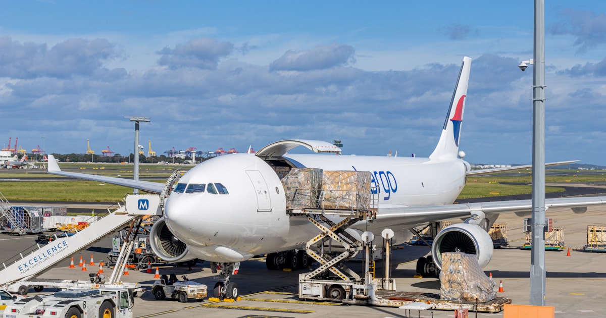 Cargo plane being loaded with freight on an airport tarmac, representing how volumetric weight is calculated for air freight