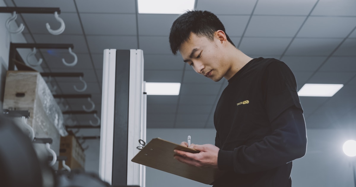 Warehouse worker checking cargo against a clipboard checklist, representing how a Bill of Lading verifies a shipment